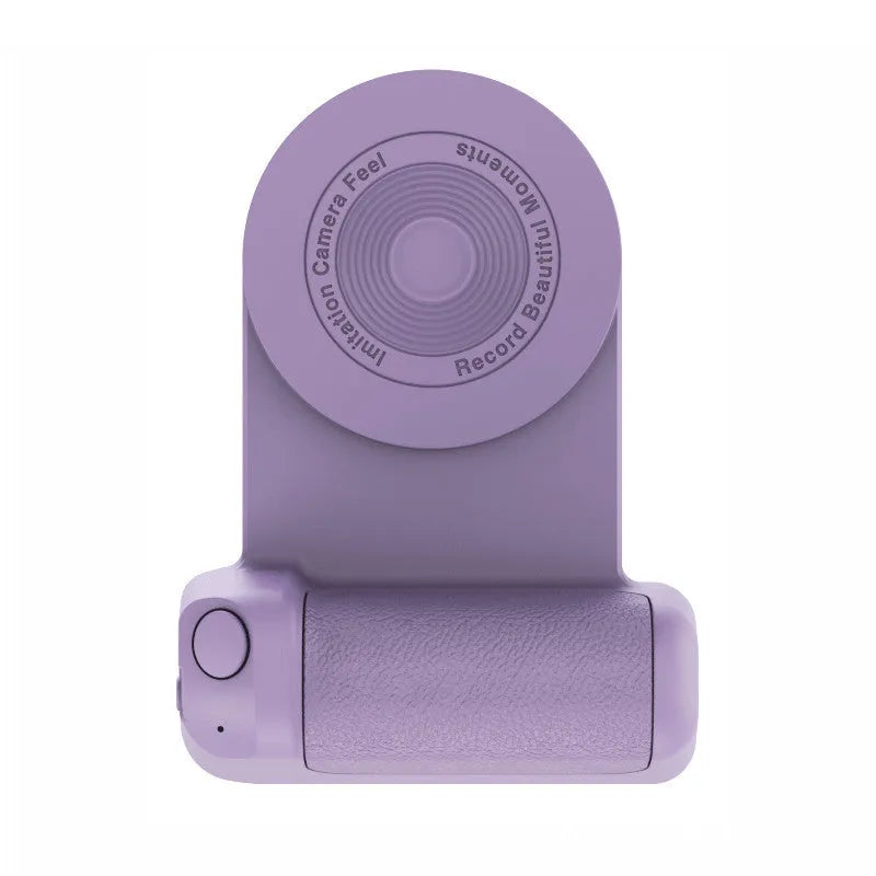 Black magnetic phone camera grip holder with rotatable stand on a table next to a smartphone.