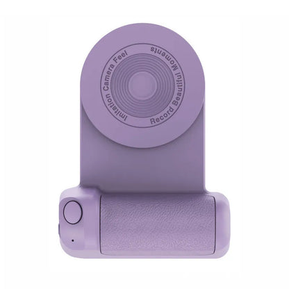 Black magnetic phone camera grip holder with rotatable stand on a table next to a smartphone.