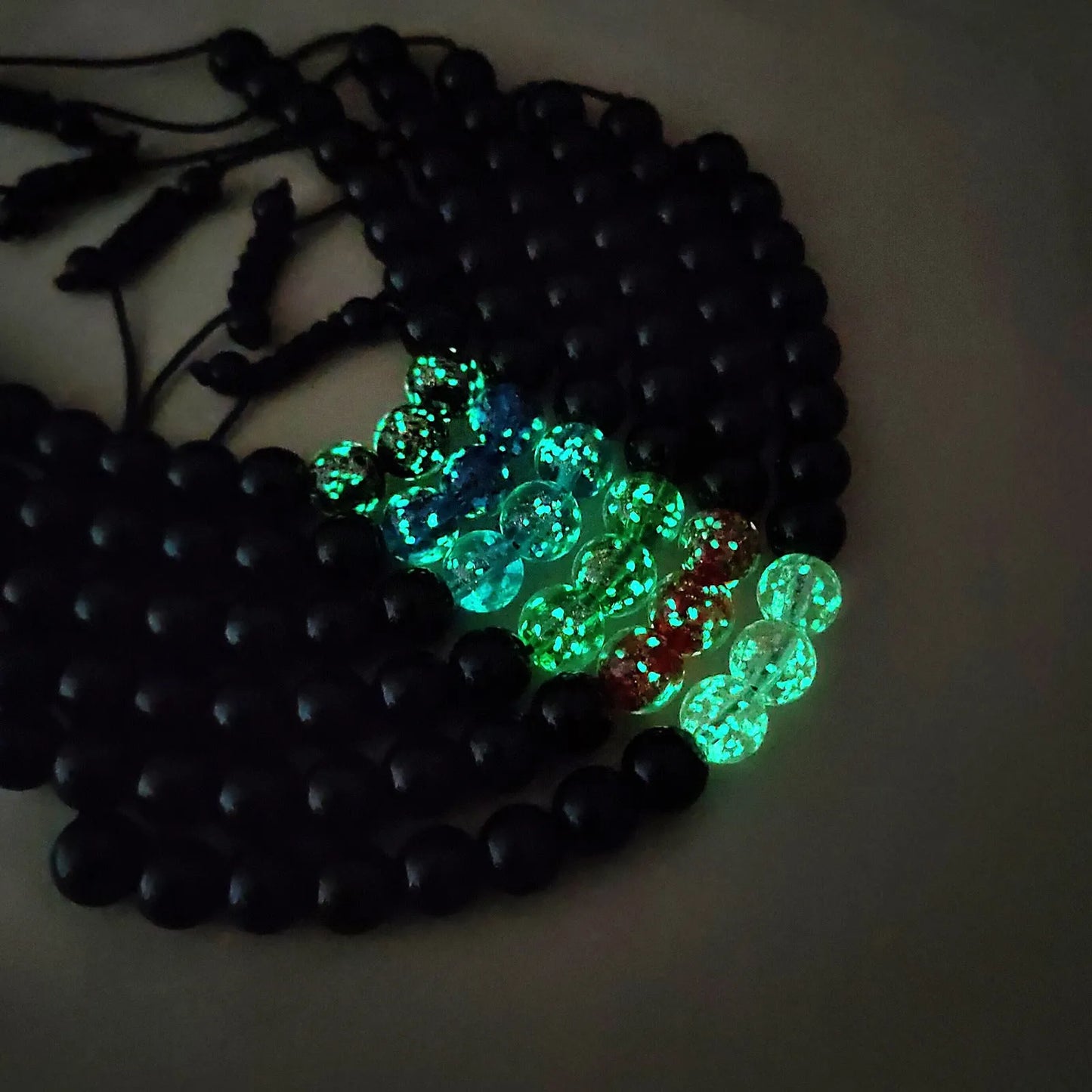 Adjustable bracelet with luminous geometric glass beads in six colour options on a wrist
