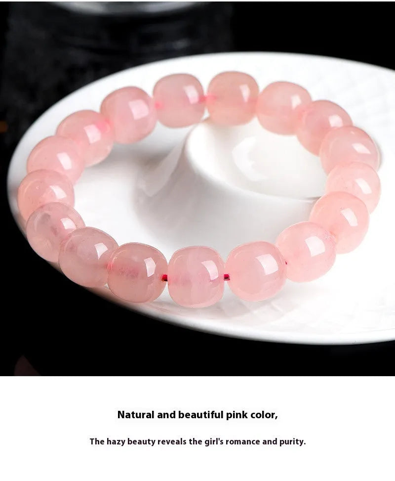 Natural crystal barrel shaped bead bracelet with 19 pink 8-10mm polished crystal beads in geometric pattern