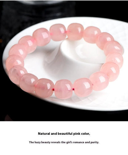 Natural crystal barrel shaped bead bracelet with 19 pink 8-10mm polished crystal beads in geometric pattern