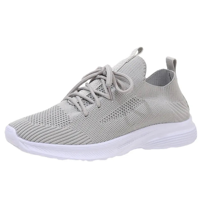 Women's low-top mesh Flyknit tennis shoes in creamy white, with a rubber sole and round toe.