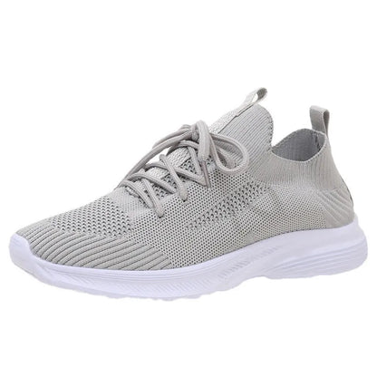 Women's low-top mesh Flyknit tennis shoes in creamy white, with a rubber sole and round toe.