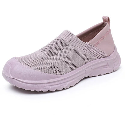 Women's one pedal slip-on shoe in black with cloth upper and PVC sole, showing round toe and flat heel design.