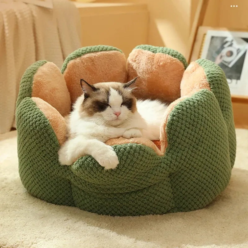 Green cactus petal shape pet bed for cats and dogs on a hardwood floor.