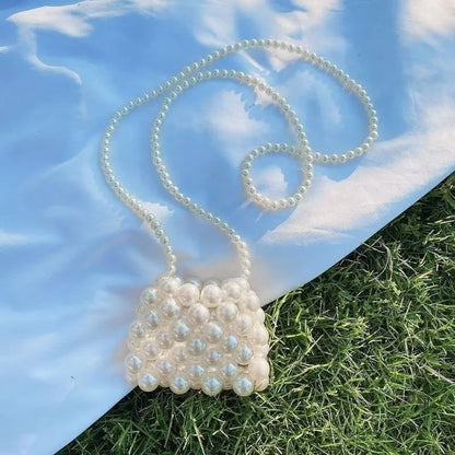 Women's imitation pearl mini crossbody handbag with geometric pattern in a pearl colour.