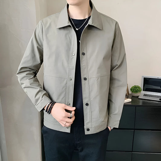 Man wearing a slim-fit black Korean-style single-layer polyester jacket for spring.