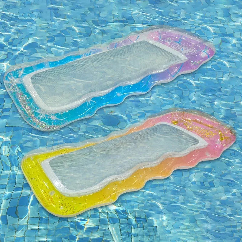 A person lounging on a large, colourful inflatable floating row with sequin details in a swimming pool.