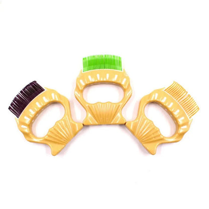 Shell-shaped plastic pet grooming brush with bent wire bristles in green, orange, or purple colours