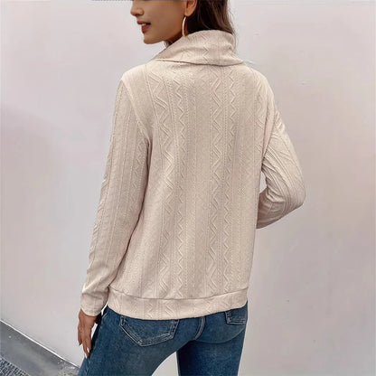 Apricot coloured long sleeve hooded pullover sweater with drawstring on a hanger