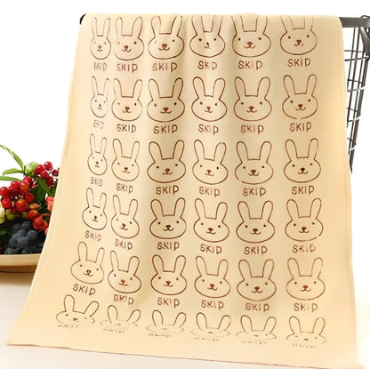 Beige microfiber bath towel demonstrating absorbency with water droplets on 600 GSM surface