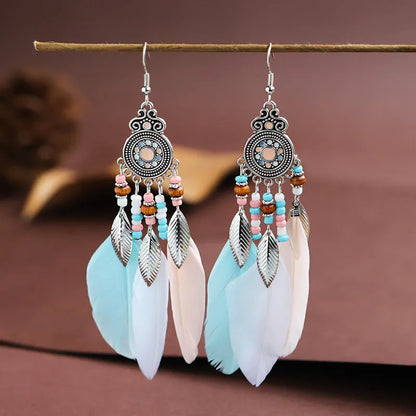 Bohemian feather leaf pattern alloy earrings in round drop shape on a colour selection background.