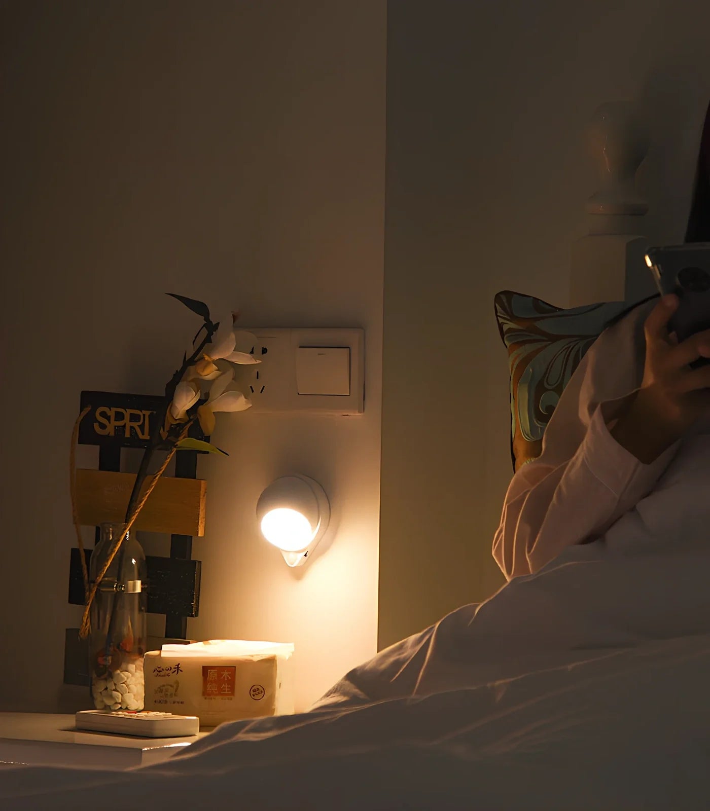 Wireless motion sensor light with USB charging port and adhesive mounting for wall installation