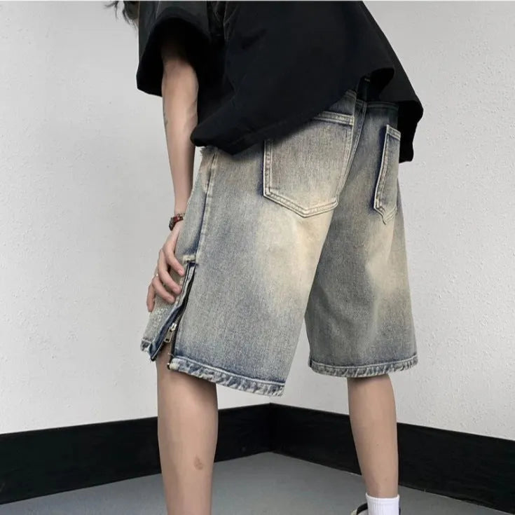 Blue denim shorts with wide-leg cut and tattered retro detailing on mannequin