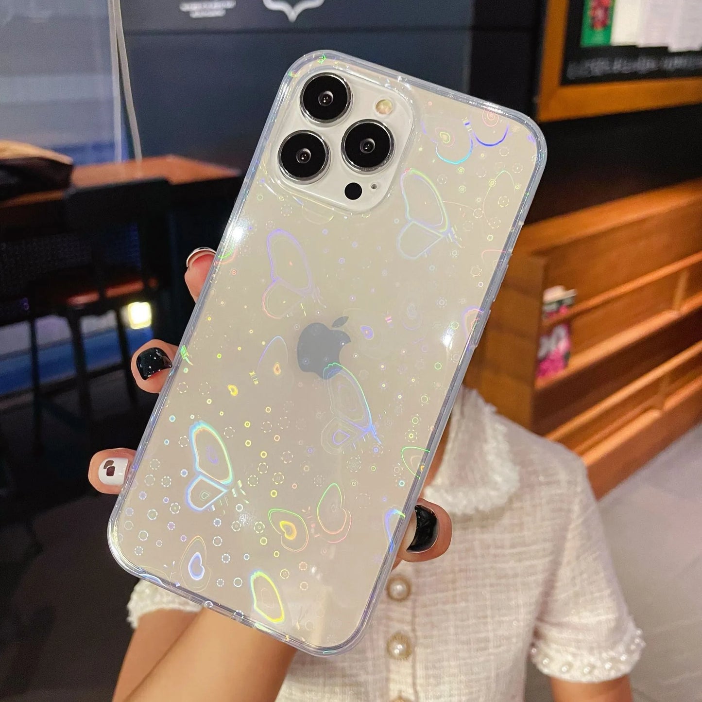 Laser colourful love silicone phone case with transparent colour and laser-etched motifs, shown on an iPhone.