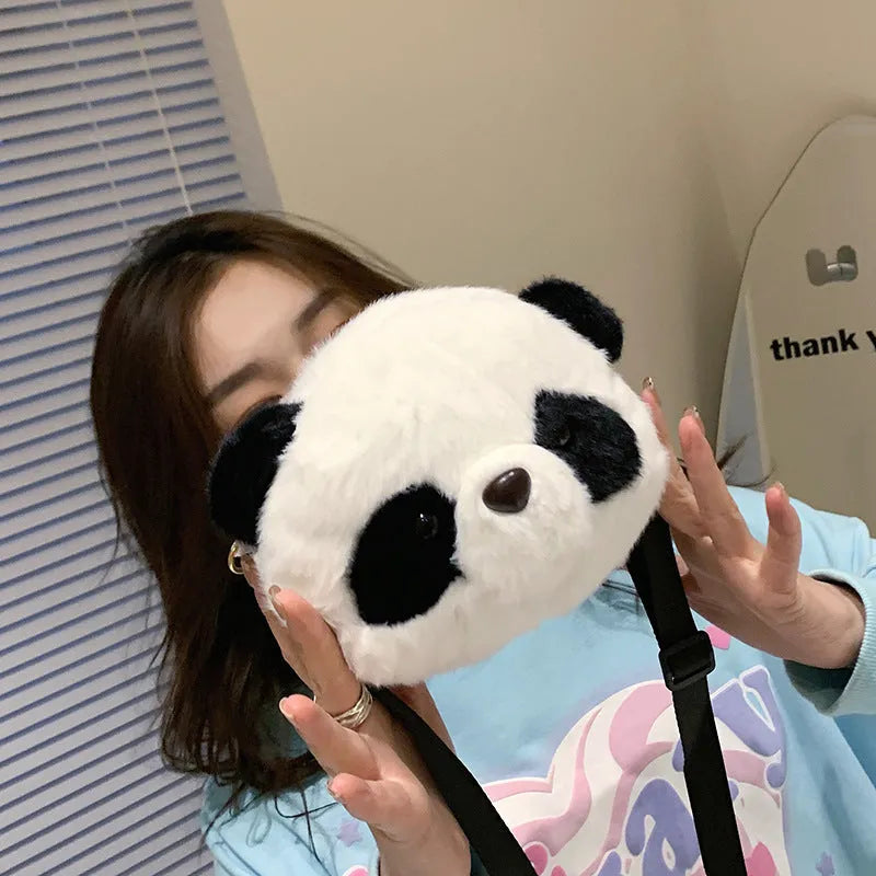 Plush panda head crossbody bag with cylindrical shape measuring 18x15x8cm, showing sandwich pocket and soft texture