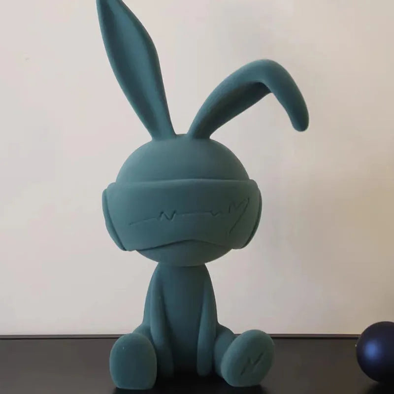Green suede blindfold rabbit resin table ornament on a wooden shelf, showing detailed texture and 12cm height