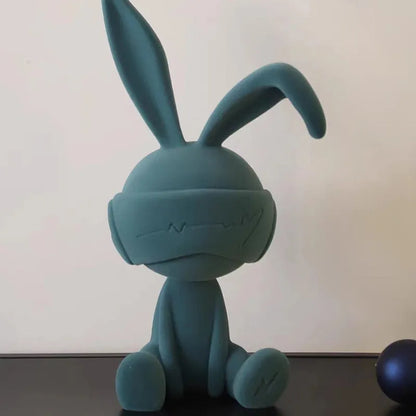 Green suede blindfold rabbit resin table ornament on a wooden shelf, showing detailed texture and 12cm height