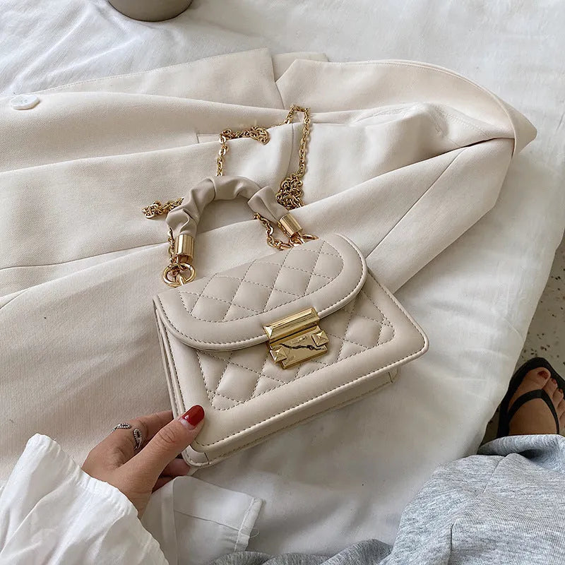 Beige rhombus-shaped women's crossbody bag with a long strap, showing front view and size.