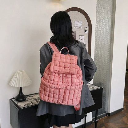 Soft, quilted puffer backpack in a variety of colors, perfect for autumn and winter wear