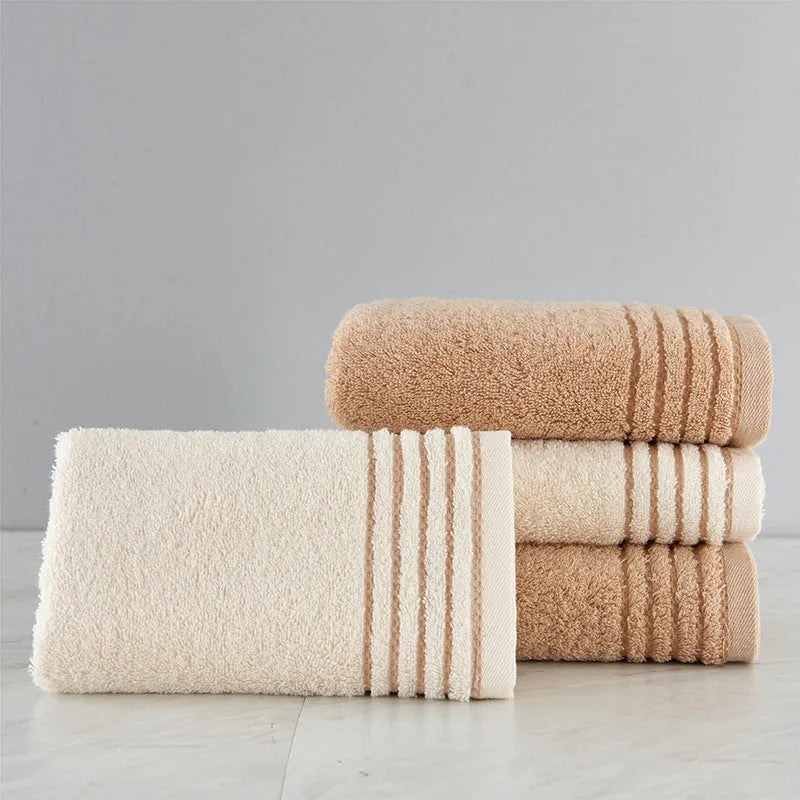 Beige and brown cotton towel set showing bath, hand, and face towel sizes.