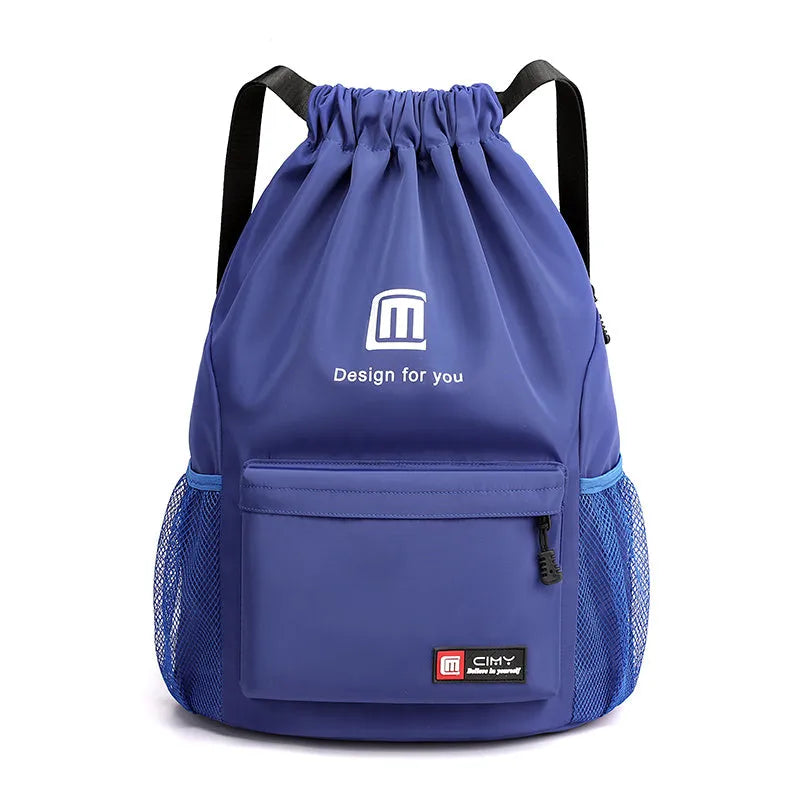 Large bucket-shaped travel backpack in blue with drawstring closure and soft black shoulder straps.