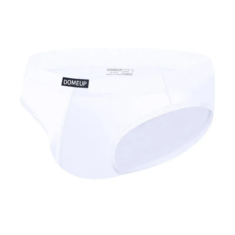 Men's solid colour seamless briefs in low waist style shown in black, white, and pink.