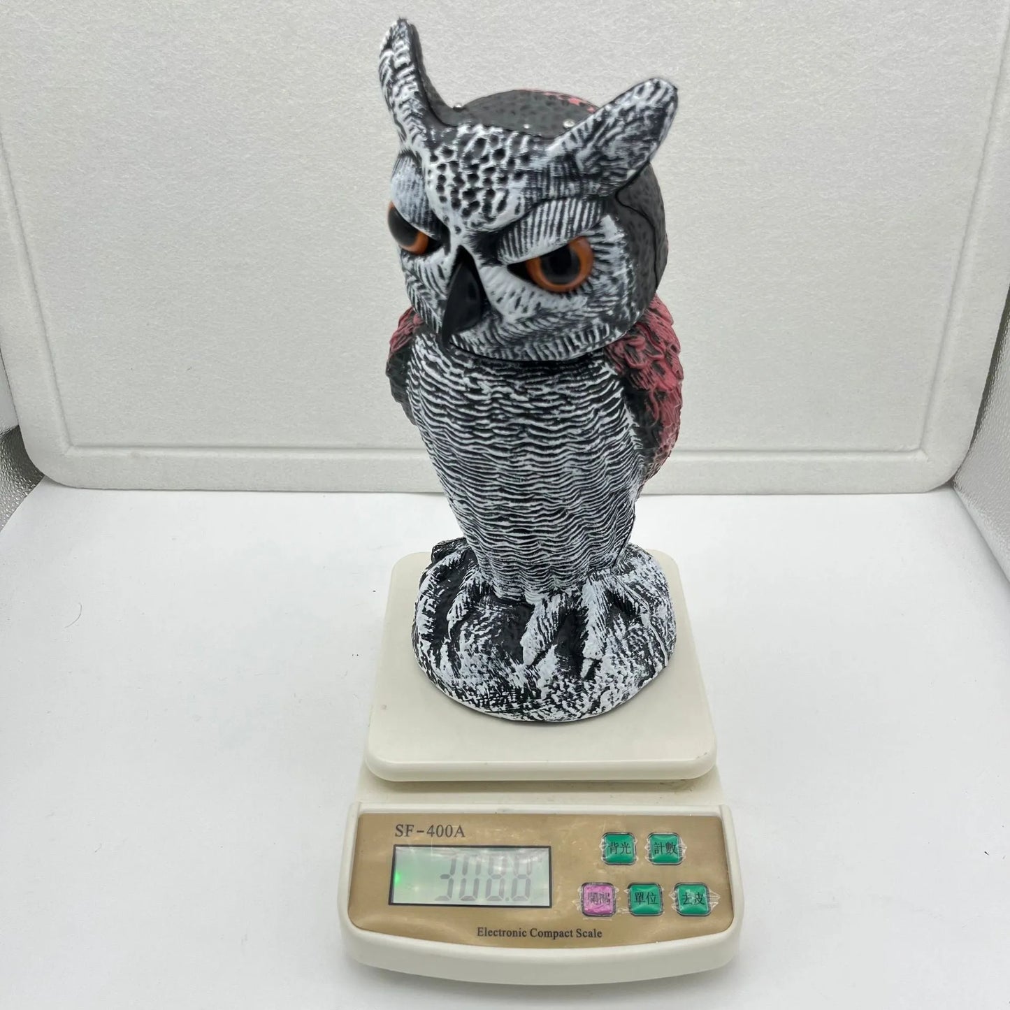 Set of artificial owl bait ornaments with shaking heads for scaring birds outdoors.