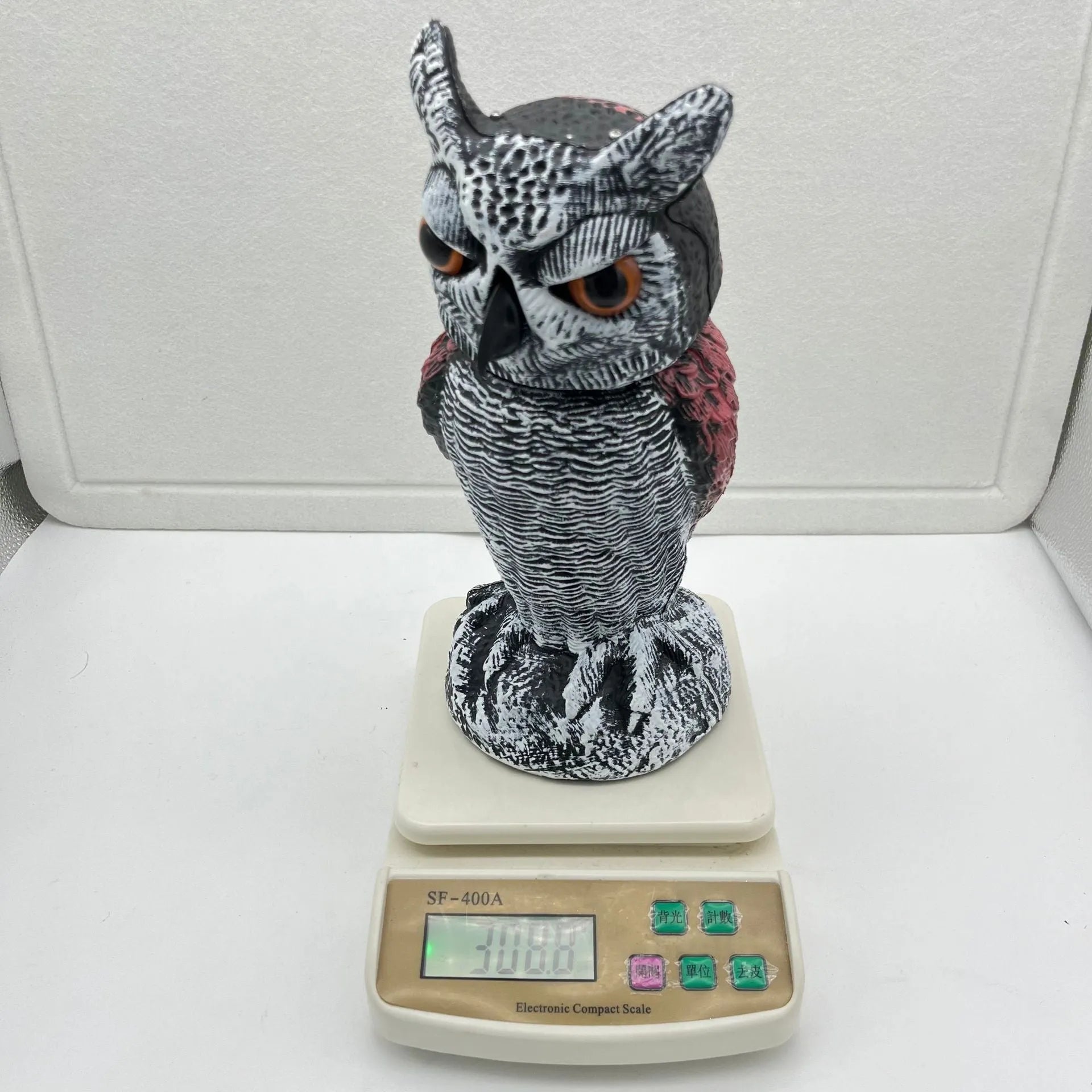 Set of artificial owl bait ornaments with shaking heads for scaring birds outdoors.