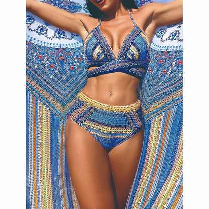 Blue cross-back bandeau top and high-waisted bikini briefs with a veiled split detail, laid flat.