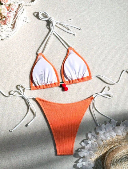 Solid colour briefs-style bikini swimsuit on a hanger, showing the top and pants.