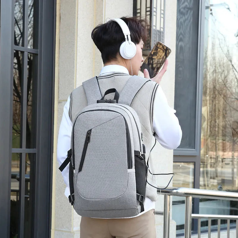 Men's grey computer backpack with 20-35L capacity showing Oxford cloth construction and organisational compartments