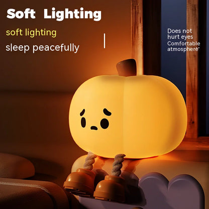 Orange silicone pumpkin night lamp measuring 98x105x83mm with built-in battery and USB charging port
