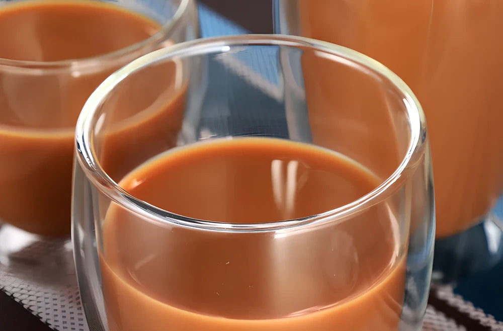Clear double-layer glass coffee cup with Chinese-style design showing insulating air gap between walls