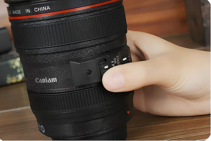 Self-stirring camera lens mug with stainless steel construction and automatic mixing button