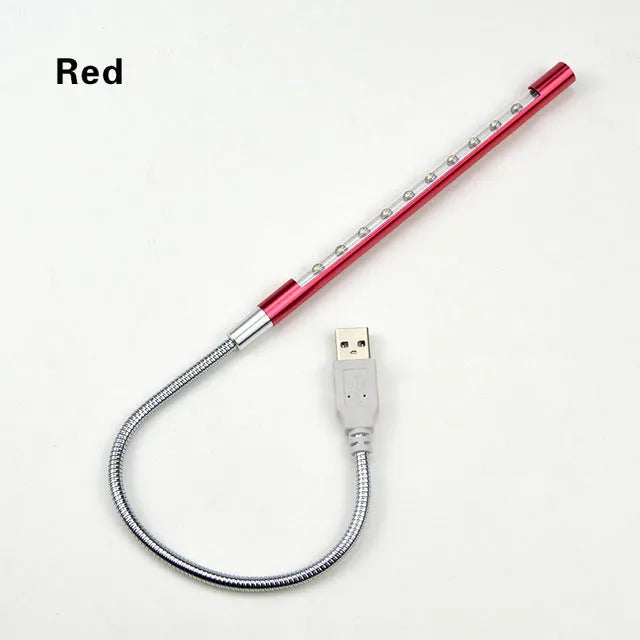 Spiral-shaped silver aluminium alloy USB LED desk lamp on a wooden table.