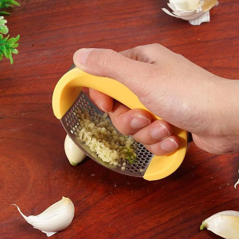 Stainless steel garlic press with ergonomic handle in kitchen setting