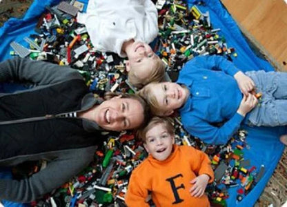 A large, waterproof travel picnic mat made of durable nylon with convenient toy storage bags for outdoor adventures.