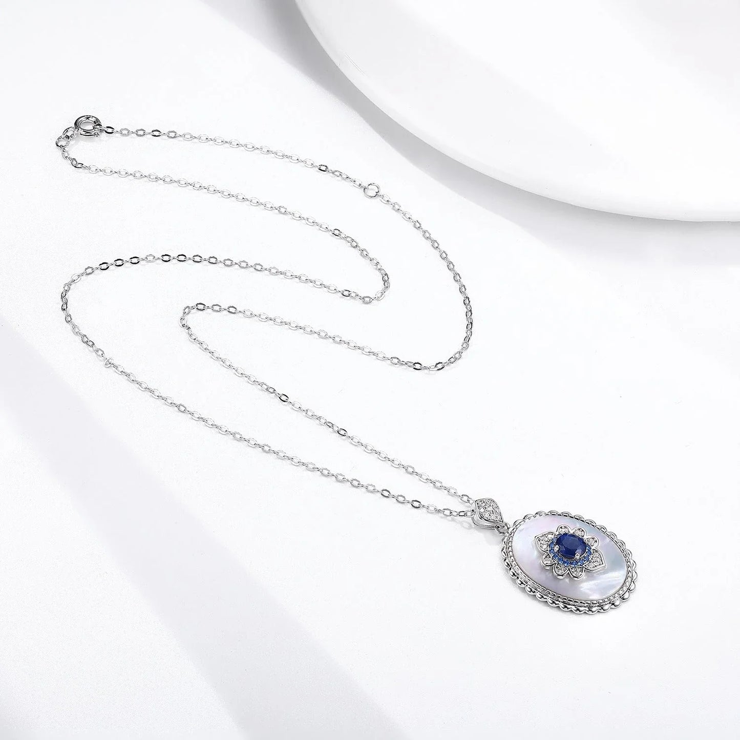 Elegant sapphire and diamond pendant necklace made of 925 sterling silver with a sleek geometric design and O-chain