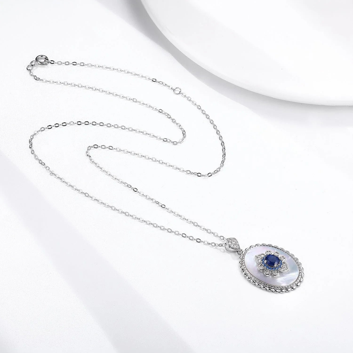 Elegant sapphire and diamond pendant necklace made of 925 sterling silver with a sleek geometric design and O-chain