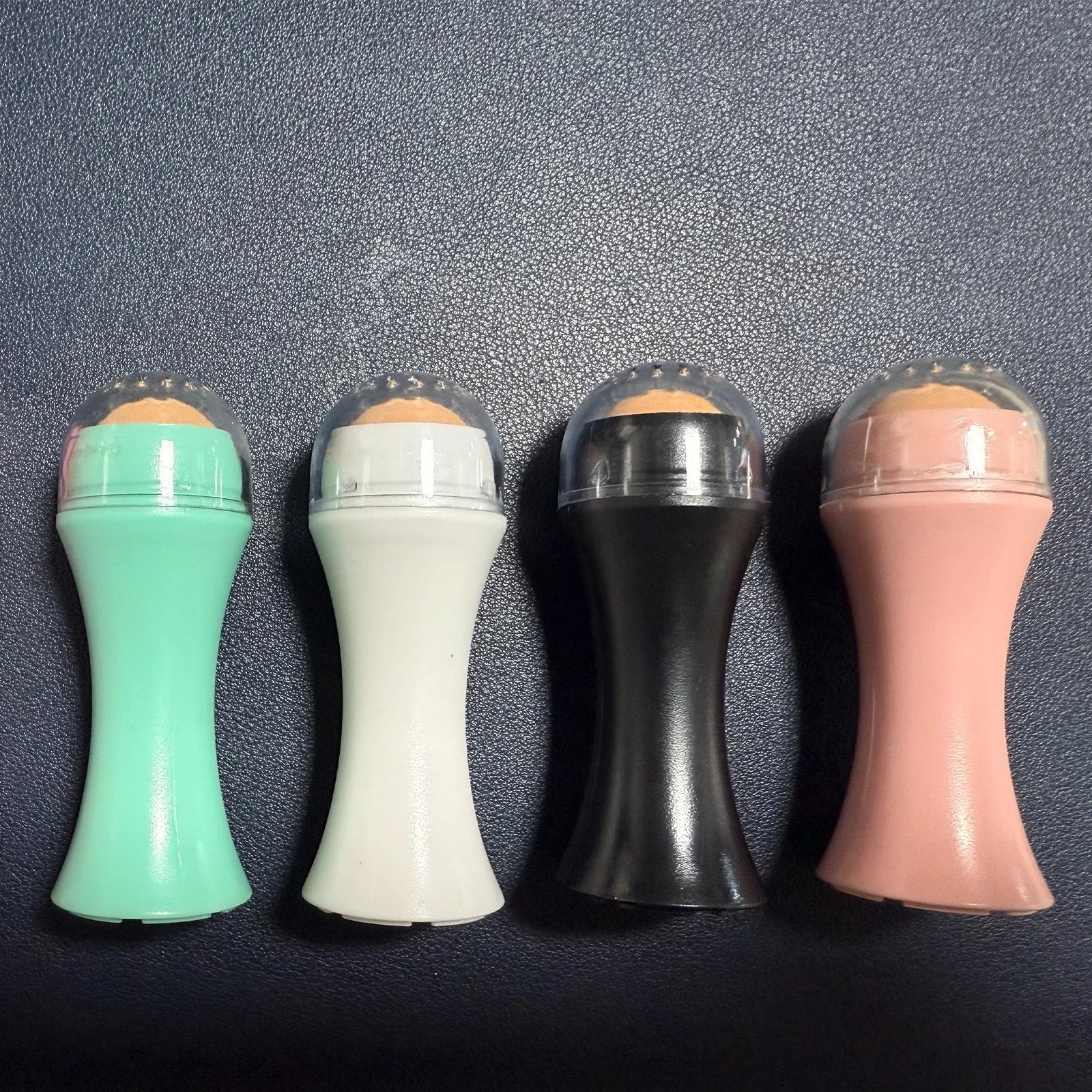 Volcanic portable roller for oily skin control, made from real volcanic stone, in black, green, pink, or white