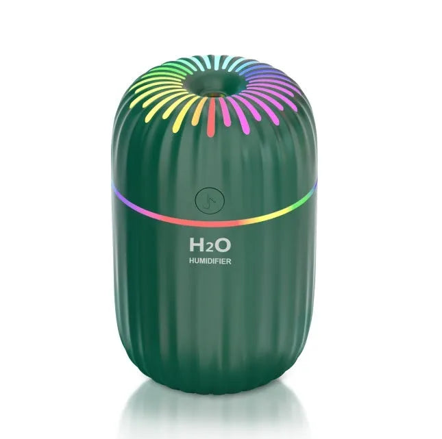 White USB mini humidifier with 300ml tank on desk beside laptop showing compact 75x75x116mm size