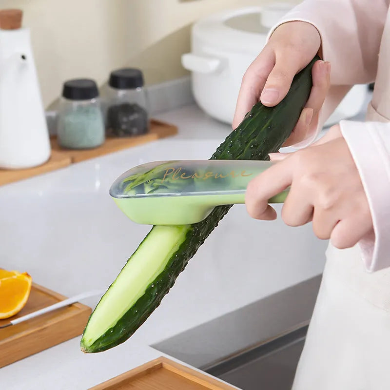 Dark green and light green kitchen peeler with storage tube and stainless steel blade