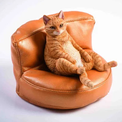 Lazy cat ornament on miniature sofa for car dashboard decoration, 7.5cm high with fabric art detailing