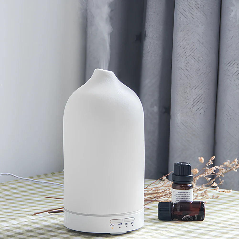 Ceramic ultrasonic aroma diffuser in white with 100ml tank, diffusing mist in home setting, 10cm diameter