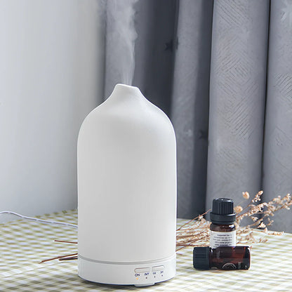 Ceramic ultrasonic aroma diffuser in white with 100ml tank, diffusing mist in home setting, 10cm diameter
