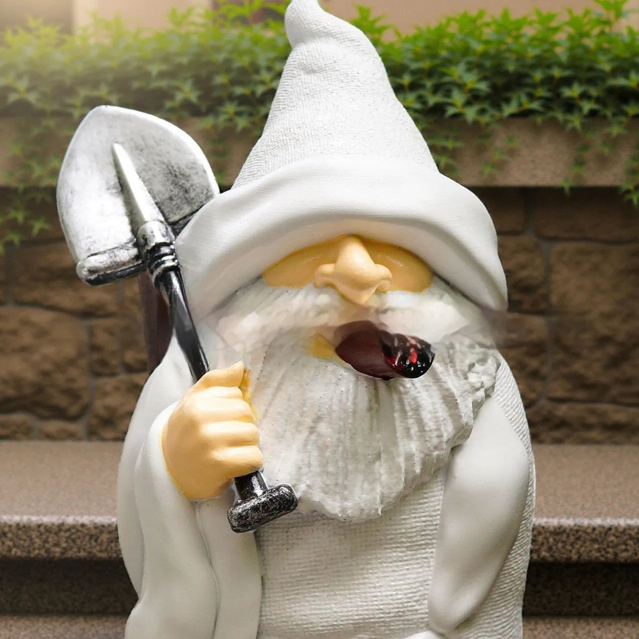 Resin Christmas garden ornament showing dwarf holding smoking shovel, 8cm height