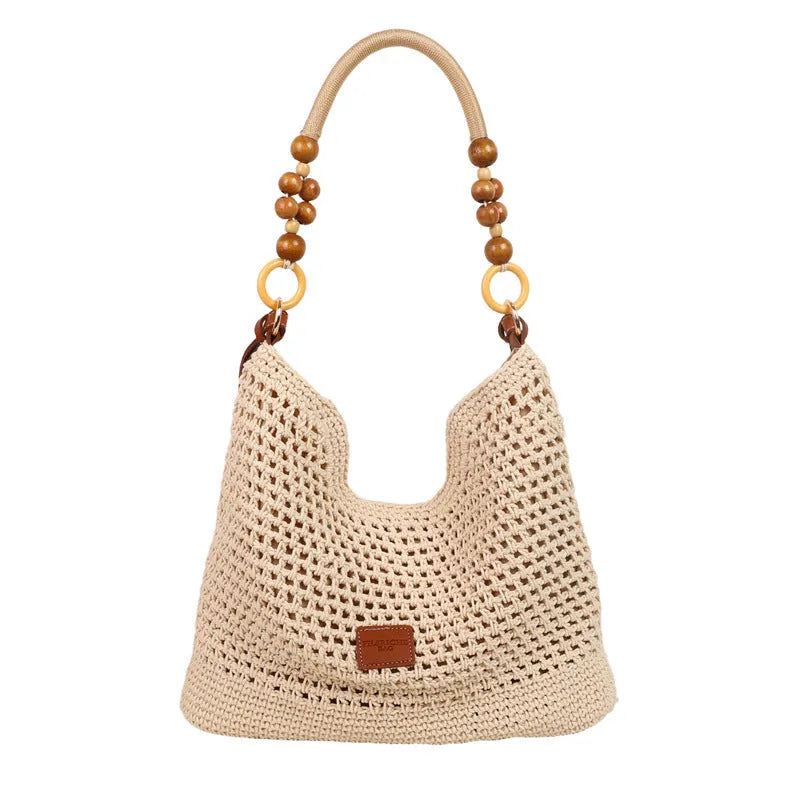 Large brown knitted bucket tote beach bag with contrast stitching and a zip internal compartment.