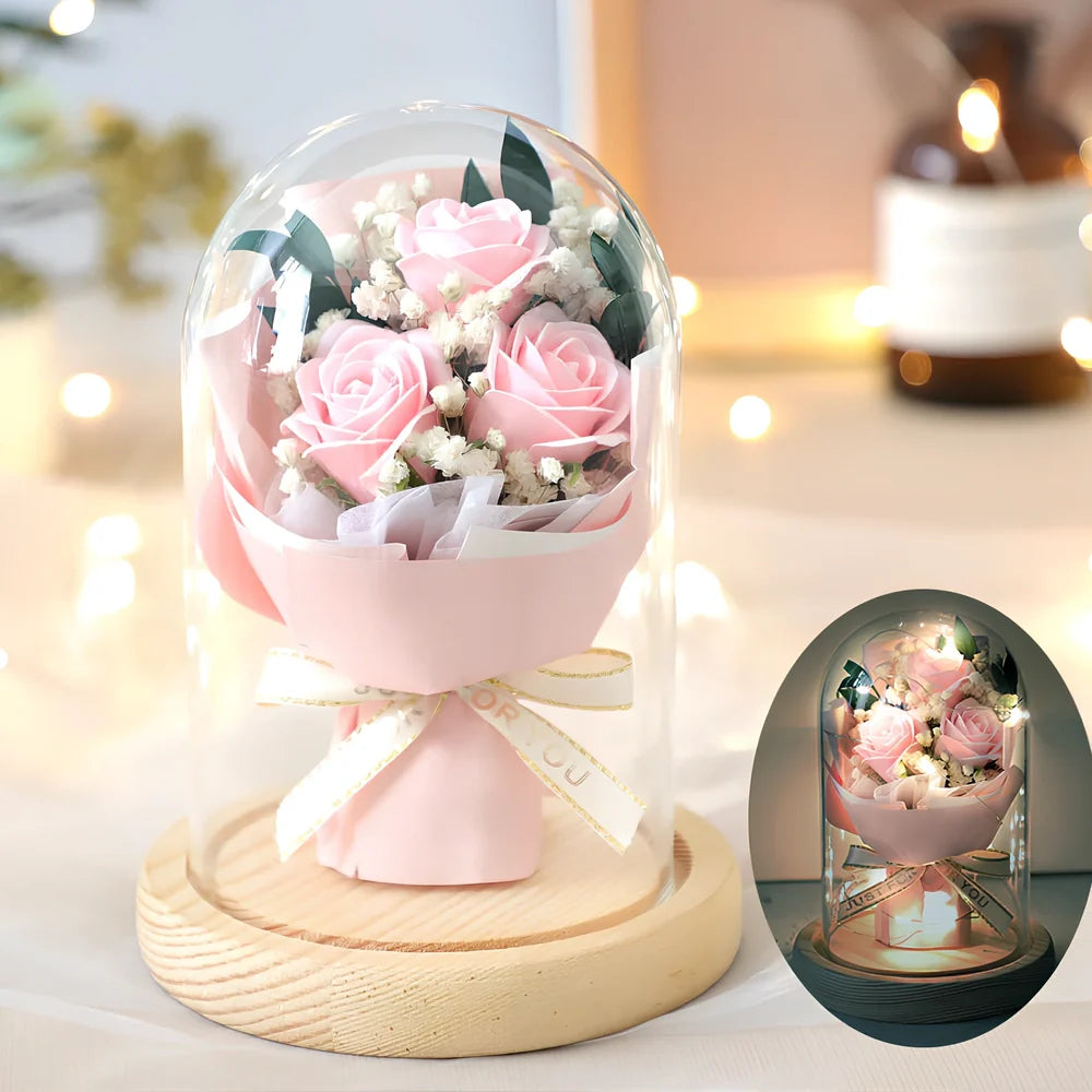 Soap flower bouquet in glass display cover with red roses visible through clear 11.2cm dome