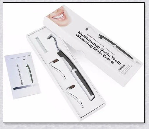 A white sonic tooth stain eraser and plaque remover with 3 different cleaning heads for removing stains and massaging gums.